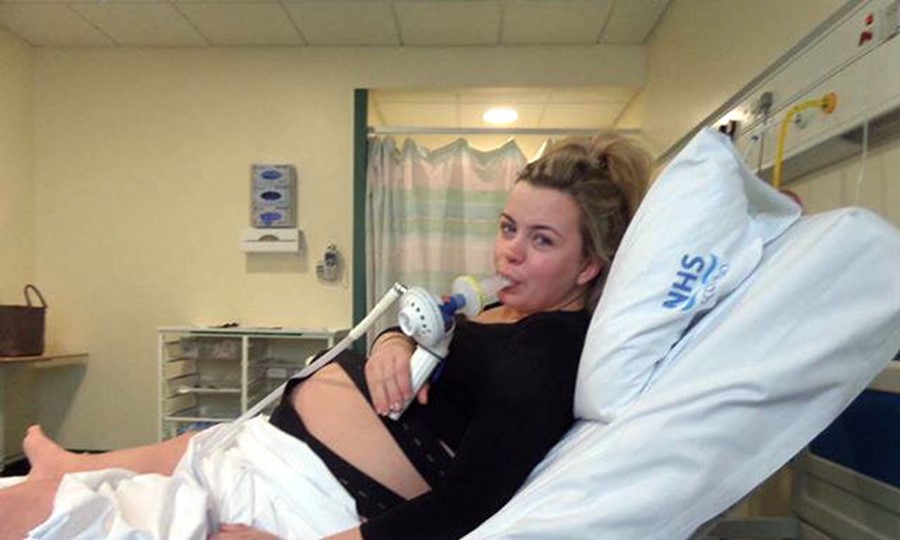 Pregnant Rhiannon lies on a hospital bed after receiving lifesaving blood donations