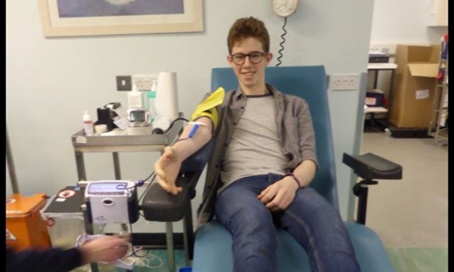 17 year old Thomas gives blood in a donor centre