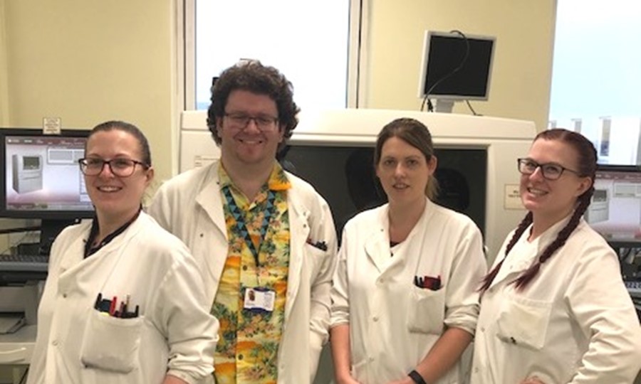 Biomedical staff from Aberdeen pose for a photo in lab coats. 
