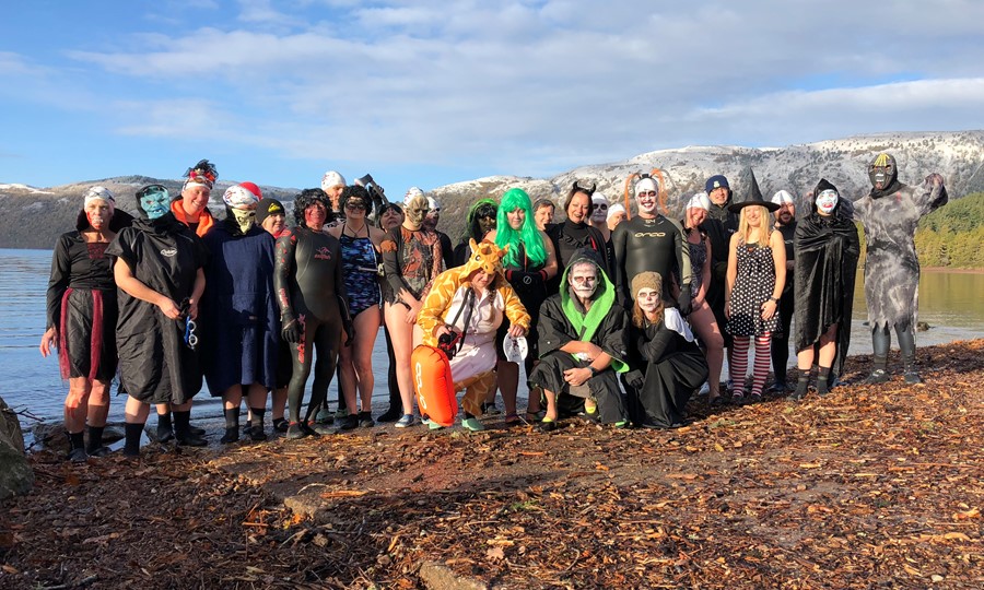 Highlanders stand on the edge of Loch Ness dressed up in Halloween fancy dress costumes.