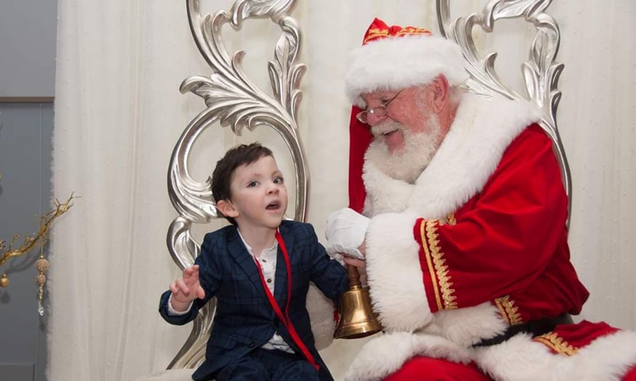 Iain smiles as he meets Santa Claus.