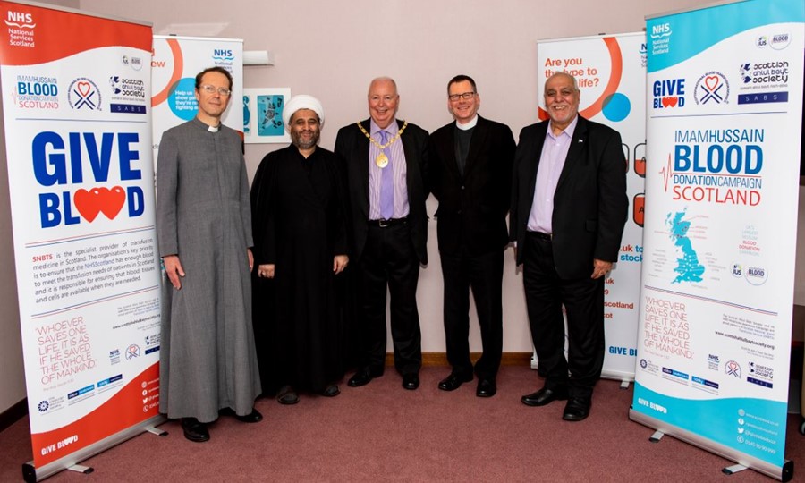 Group photo of faith leaders standing with East Renfrewshire Provost for photograph. 