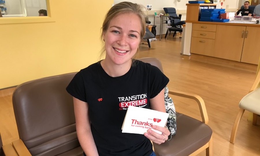 Linzi proudly holds her blood type badge. 