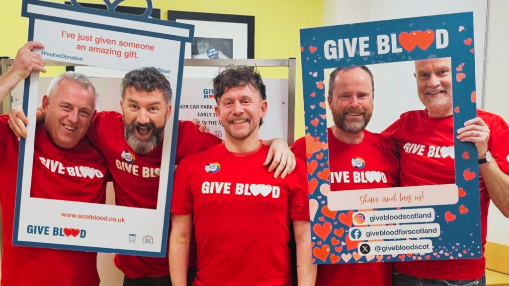 Five of the baltic boys wearing Give Blood t-shirts posing at Aberdeen blood donor centre